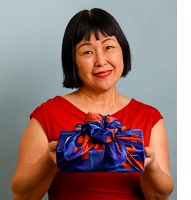 Keiko Kira holding Zinnia wrapped box.