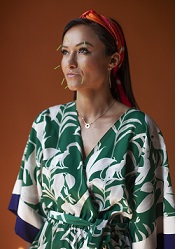 Gudrun Wu Snyder in green and white patterned dress with acupunture needles in face.